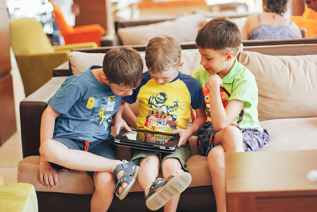 Young child using an educational tablet to explore emotions and learning concepts